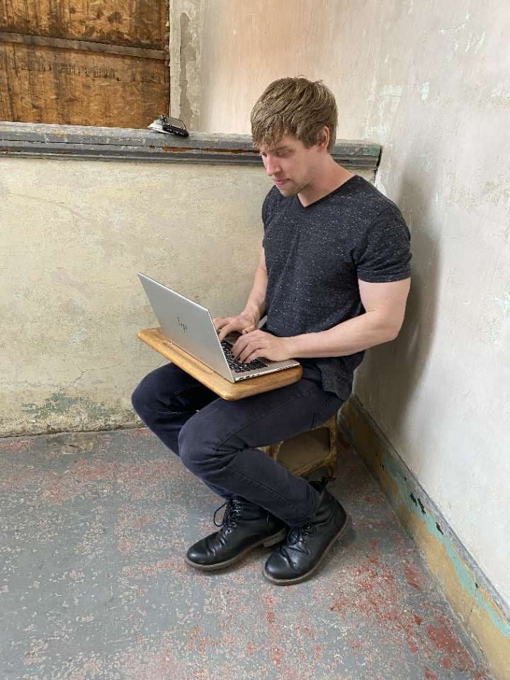 Doofus sitting is a small chair